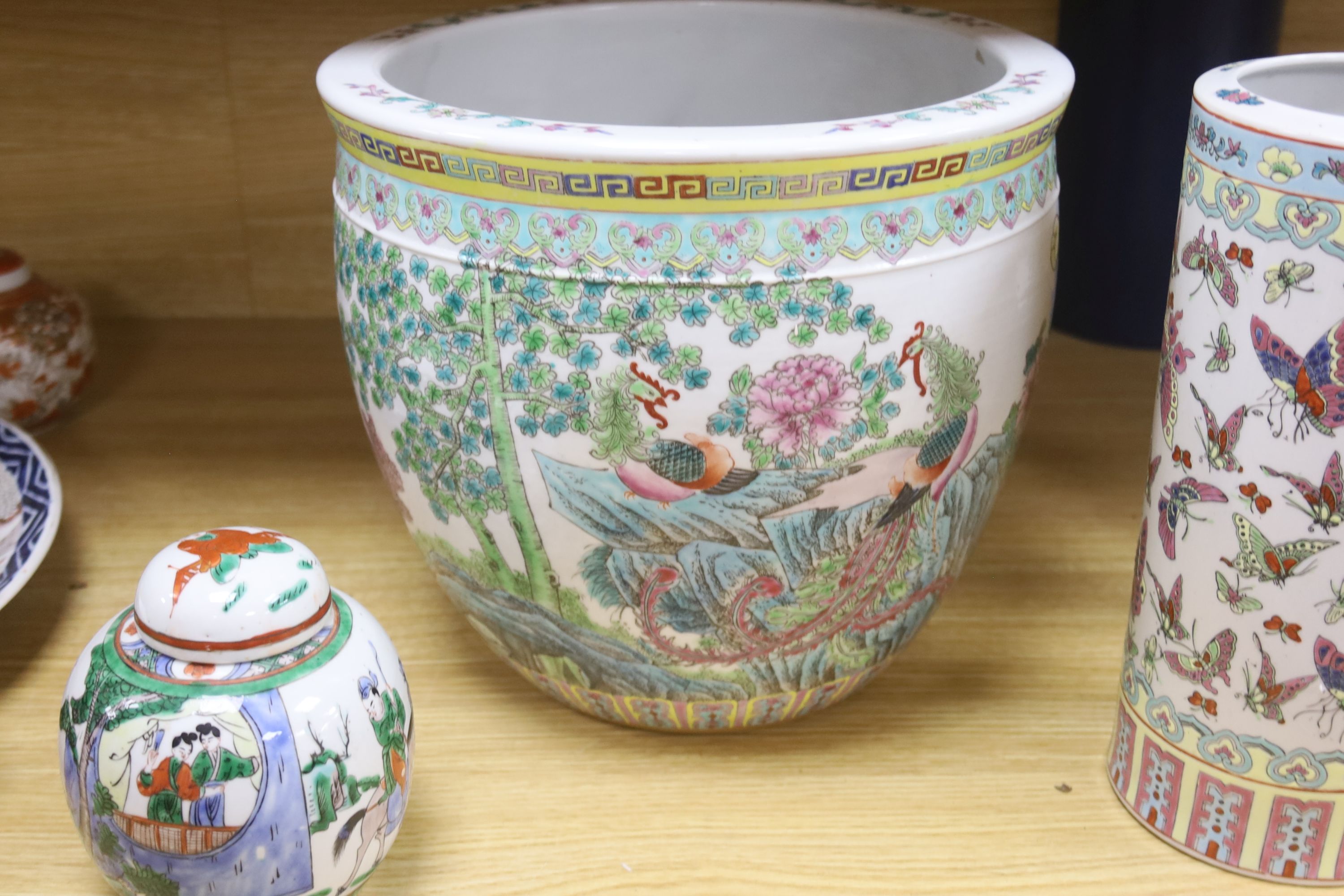 A Chinese famille rose jardiniere, a late 19th century famille rose narcissus pot, a cylindrical vase and a famille verte jar and cover, tallest 28.5cm